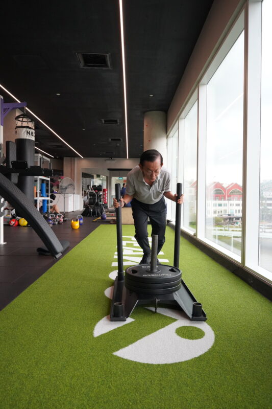 A senior member training balance and strength with a coach